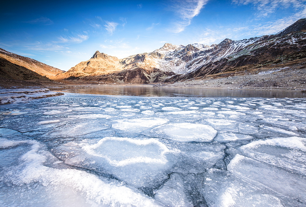 Frozen lake Montespluga at dawn, Chiavenna Valley, Sondrio province, Valtellina, Lombardy, Italy, Europe