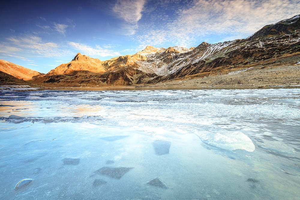 Frozen lake Montespluga at dawn, Chiavenna Valley, Sondrio province, Valtellina, Lombardy, Italy, Europe