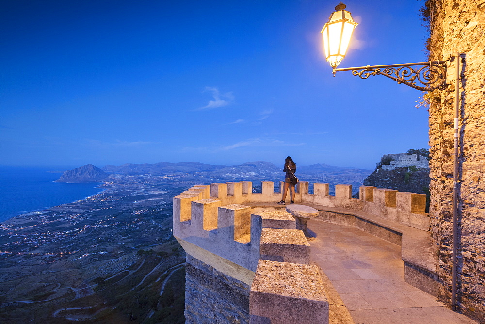 Woman on terrace looks towards Monte Cofano, Erice, province of Trapani, Sicily, Italy, Mediterranean, Europe