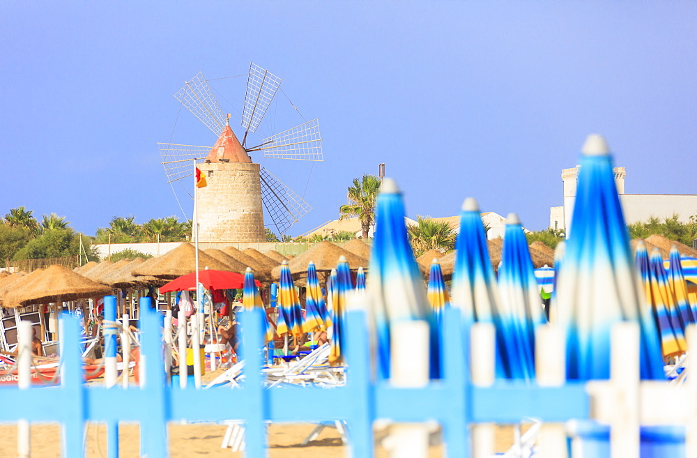 Beach umbrellas and windmill, Baia dei Mulini, Trapani, Sicily, Italy, Mediterranean, Europe