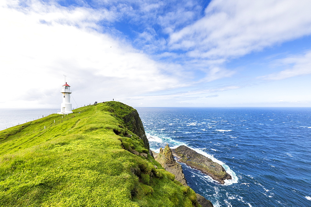 Lighthouse on islet known as Mykines Holmur, Mykines Island, Faroe Islands, Denmark, Europe