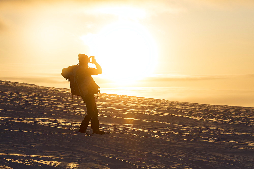 Photographer at sunset, Pallas-Yllastunturi National Park, Muonio, Lapland, Finland, Europe