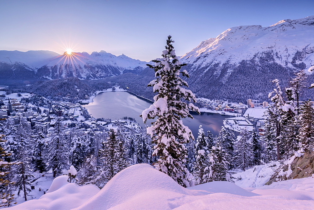 Sunrise over village and Lake of St. Moritz covered with snow, Engadine, Canton of Graubunden, Switzerland, Europe