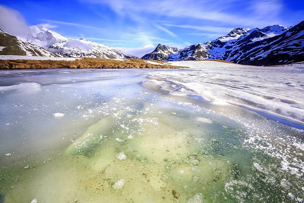 Ice melting at Lake Andossi during spring thaw, Chiavenna Valley, Spluga Valley, Sondrio province, Valtellina, Lombardy, Italy, Europe