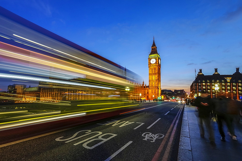 Doubledecker bus runs towards Big Ben (Elizabeth Tower), located north end of the Palace of Westminster, London, England, United Kingdom, Europe