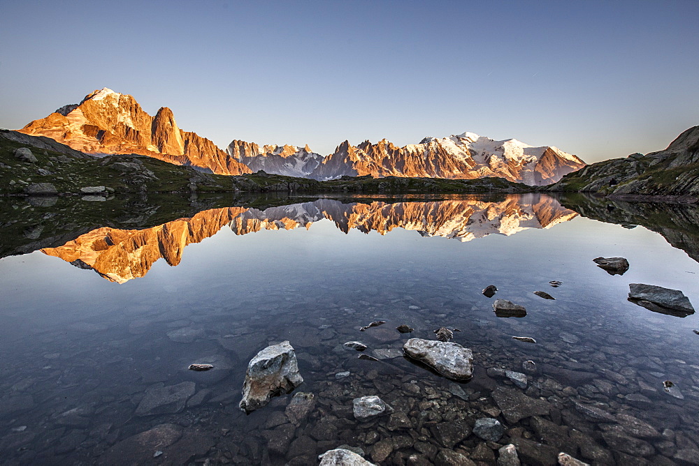 Mont Blanc range reflected at sunrise from the shore of Lac des Cheserys, Aiguilles Rouges, Chamonix, Haute Savoie, French Alps, France, Europe 