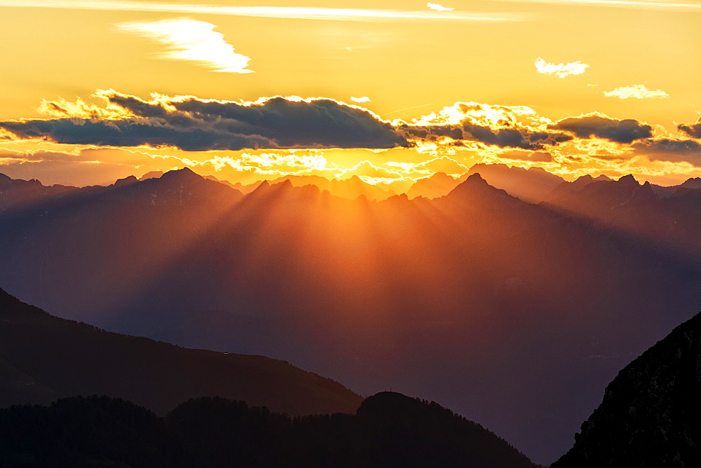 Sun rays at sunset on Pizzo Berro and Gerola Valley seen from San Marco Pass, Orobie Alps, Bergamo province, Lombardy, Italy, Europe