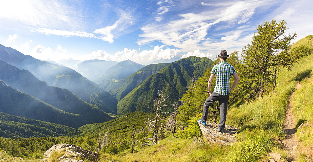 Panoramic of man on Monte Legnoncino with Valvarrone and Valsassina in the background, Lecco province, Lombardy, Italy, Europe