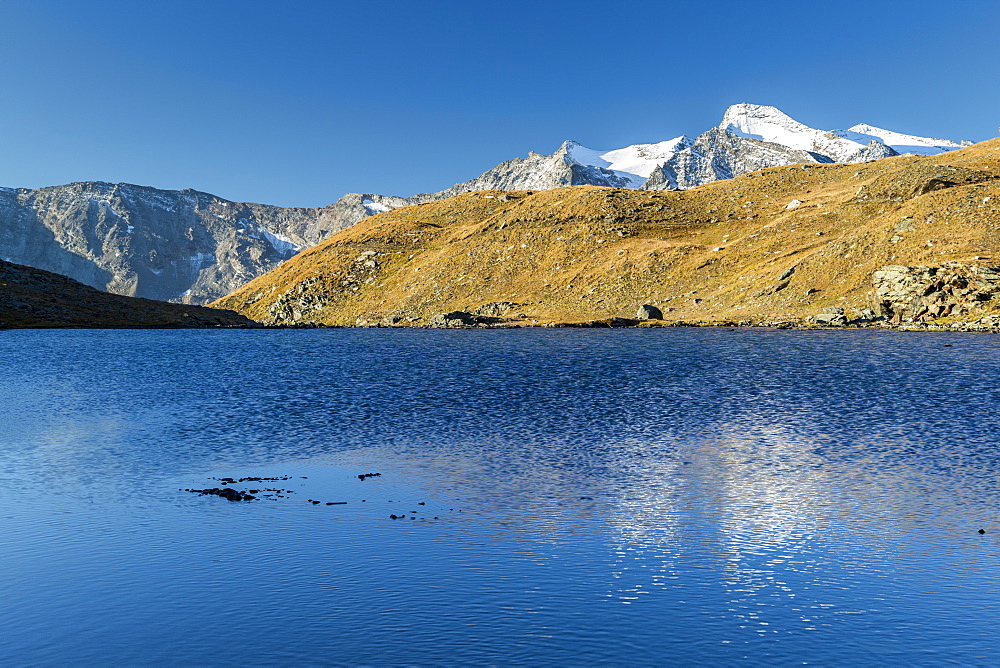 Sunrise and reflections on Aiguille Rousse, Gran Paradiso National Park, Alpi Graie (Graian Alps), Italy, Europe 