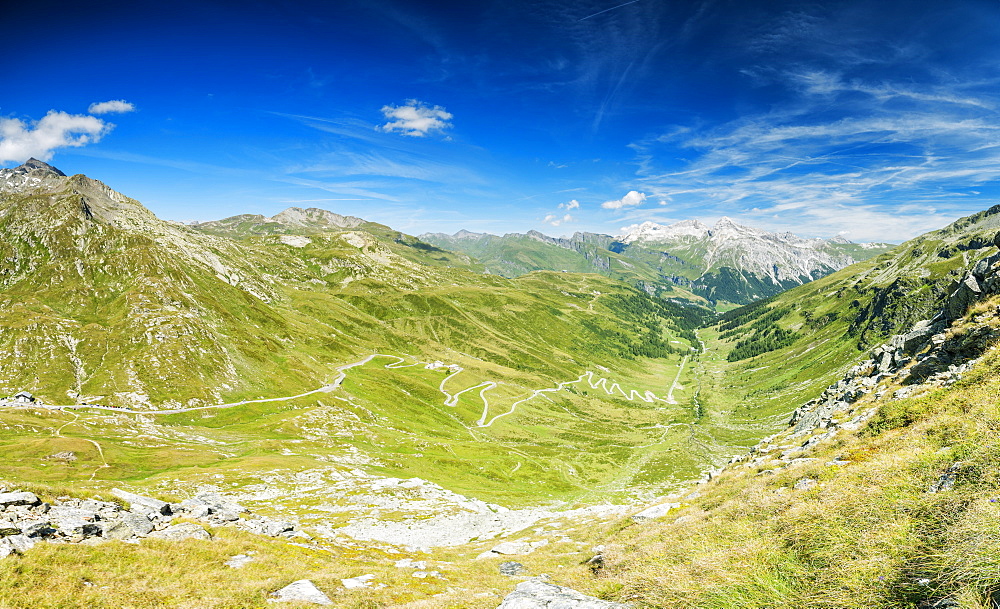 Panoramic of winding road and green valley towards the village of Splugen, Spluga Pass, canton of Graubunden, Switzerland, Europe