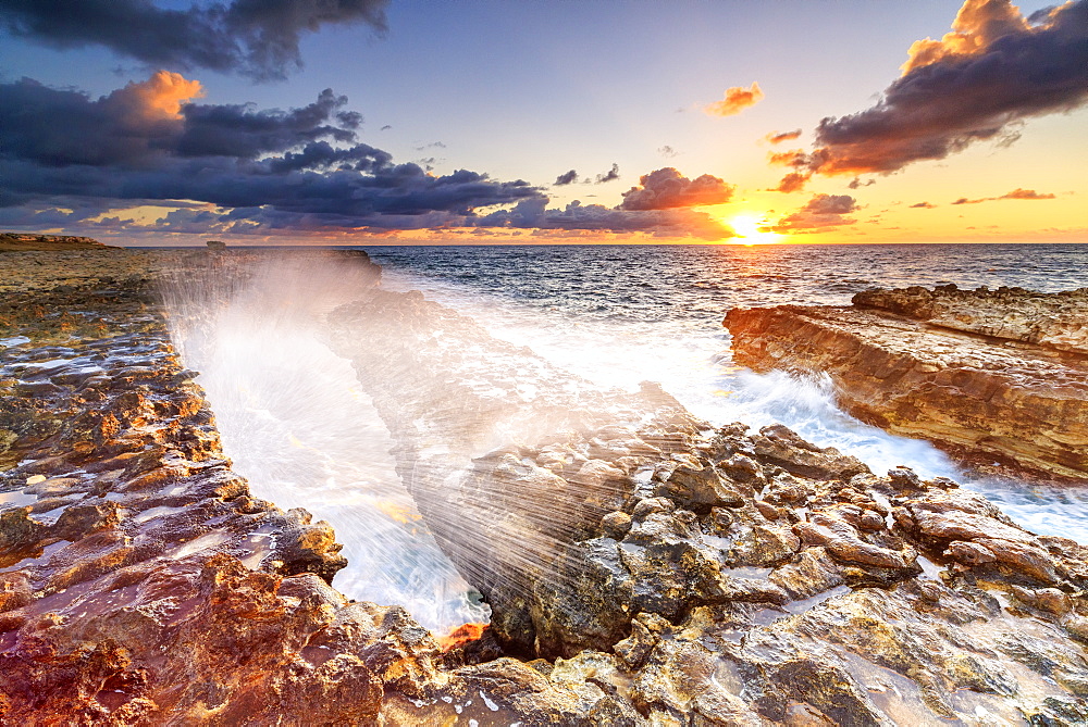 Waves crashing on cliffs at sunrise, Devil's Bridge, Antigua, Antigua and Barbuda, Leeward Islands, West Indies, Caribbean, Central America