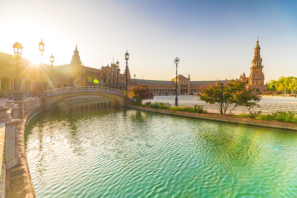 Sunrise over the decorated buildings and bridges along the canal, Plaza de Espana, Seville, Andalusia, Spain, Europe