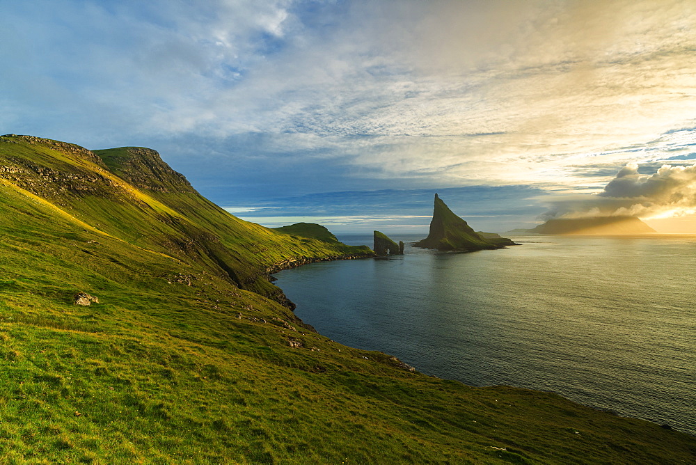 Drangarnir rock seen from the green hills along the hiking trail, Vagar island, Faroe Islands, Denmark, Europe