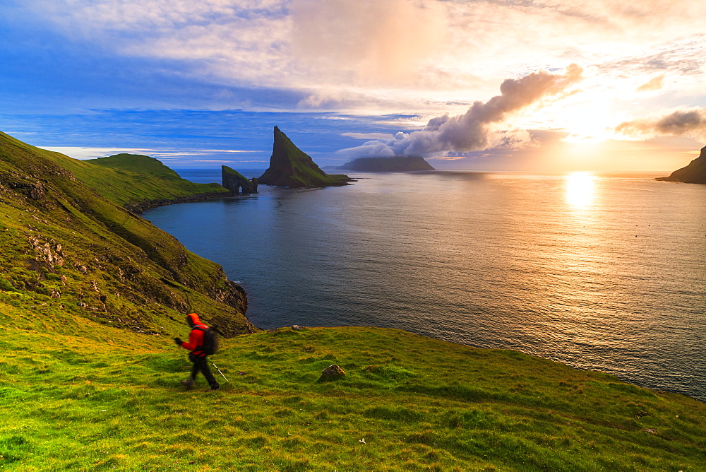 Trekker on the hiking trail to Drangarnir rock, Vagar island, Faroe Islands, Denmark, Europe