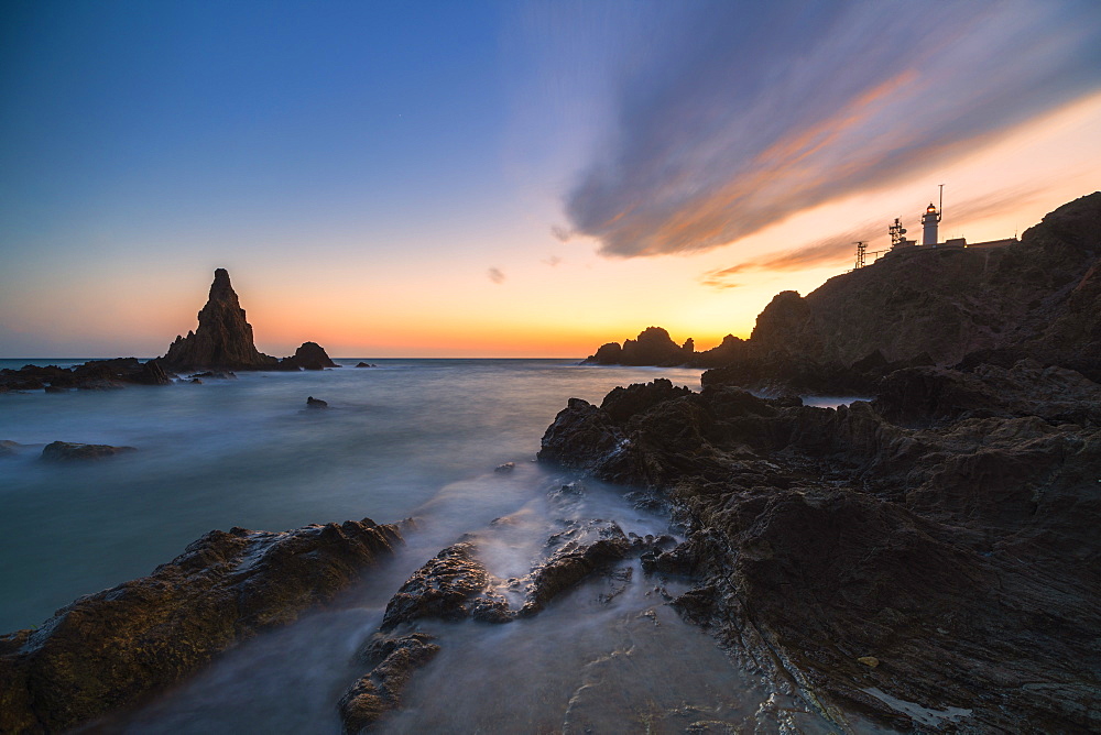 Coastline with lighthouse at sunset in Cabo de Gata-Nijar Natural Park, Spain, Europe