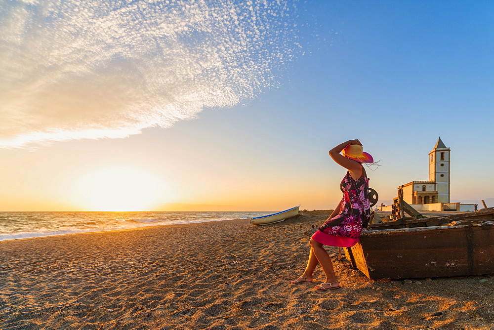 Woman on Iglesia de Las Salinas beach at sunset in Cabo de Gata-Nijar Natural Park, Spain, Europe