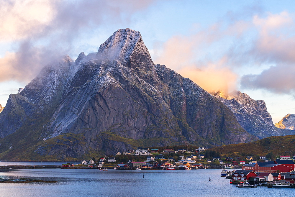 Olstinden mountain above town at sunset in Reine, Moskenes, Norway, Europe