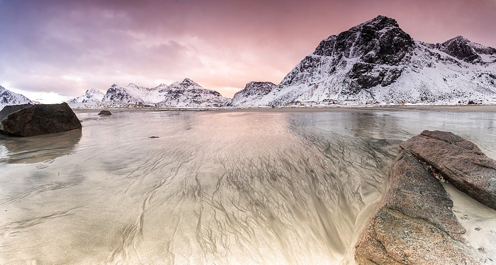 Sunset on the surreal Skagsanden beach surrounded by snow covered mountains, Flakstad, Lofoten Islands, Arctic, Norway, Scandinavia, Europe