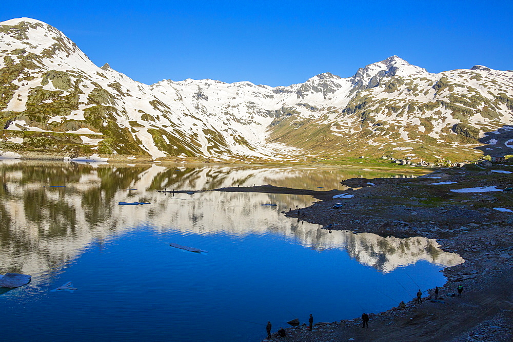 Fishermen on shores of Lake Montespluga at dawn, Valchiavenna, Valle Spluga, Sondrio province, Valtellina, Lombardy, Italy, Europe