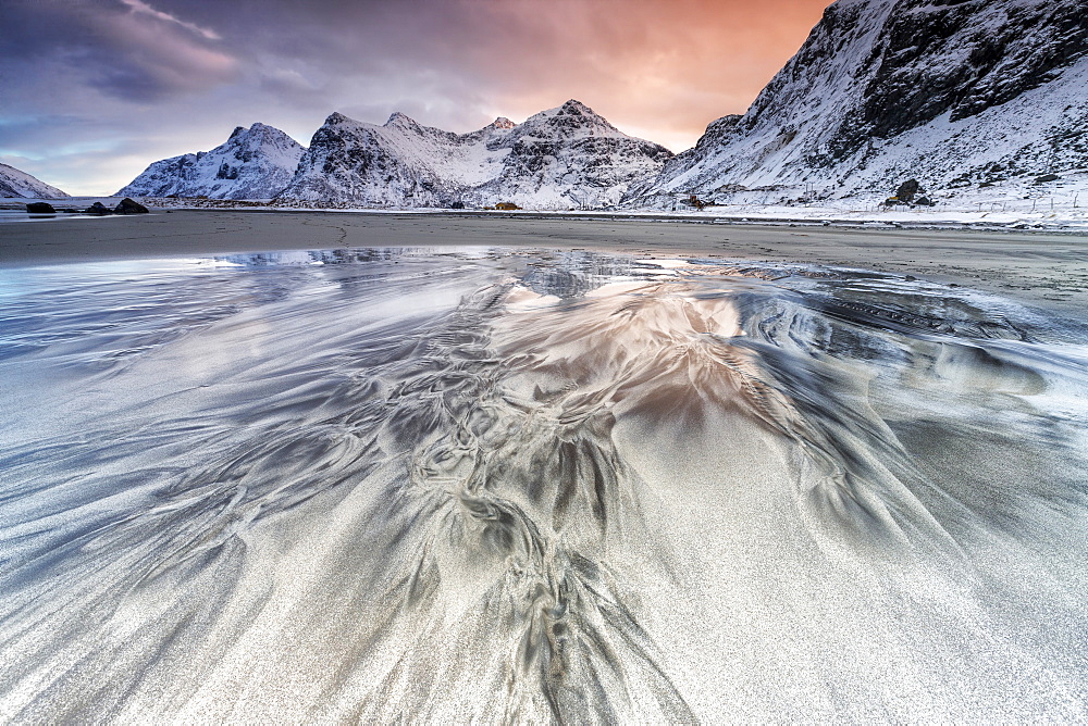 Sunset on the surreal Skagsanden beach surrounded by snow covered mountains, Flakstad, Lofoten Islands, Arctic, Norway, Scandinavia, Europe