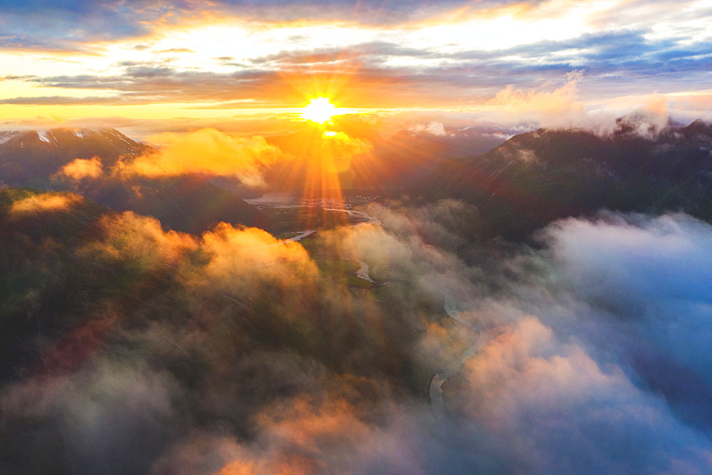 Aerial view of sun rays at sunset lighting up the clouds over Romsdalen valley, Andalsnes, More og Romsdal county, Norway, Scandinavia, Europe