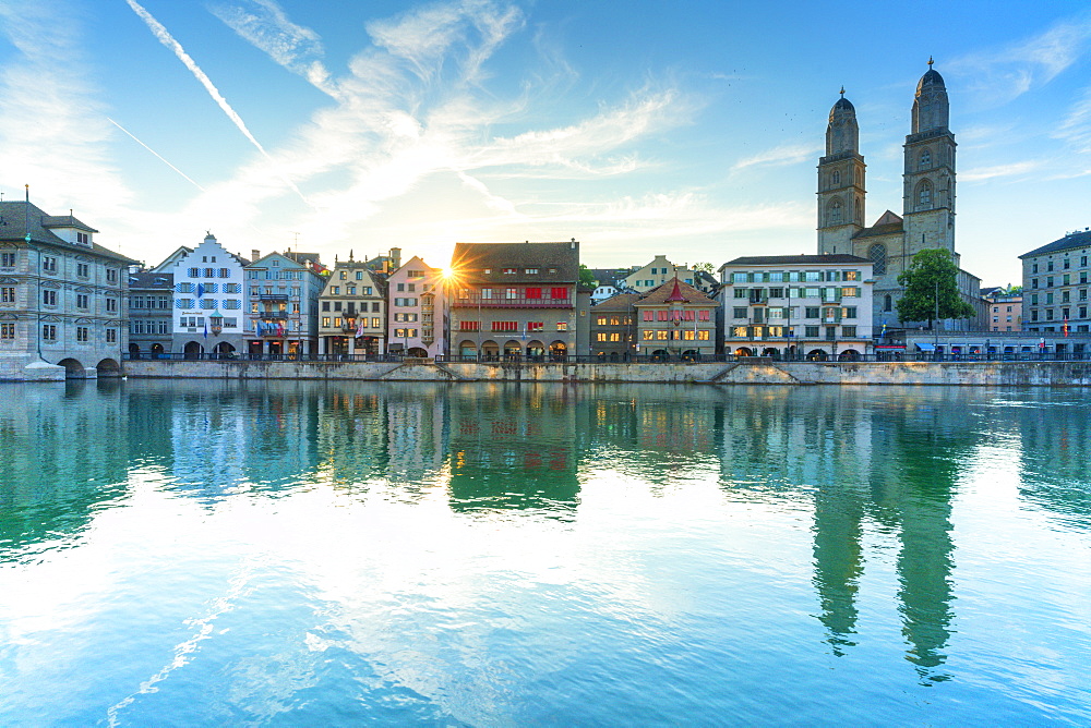 Limmatquai and Grossmunster Cathedral mirrored in Limmat River at dawn, Zurich, Switzerland, Europe