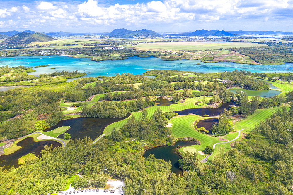 Aerial by drone of golf courses in the lush vegetation of the tropical lagoon, Ile Aux Cerfs, Flacq district, Mauritius, Indian Ocean, Africa