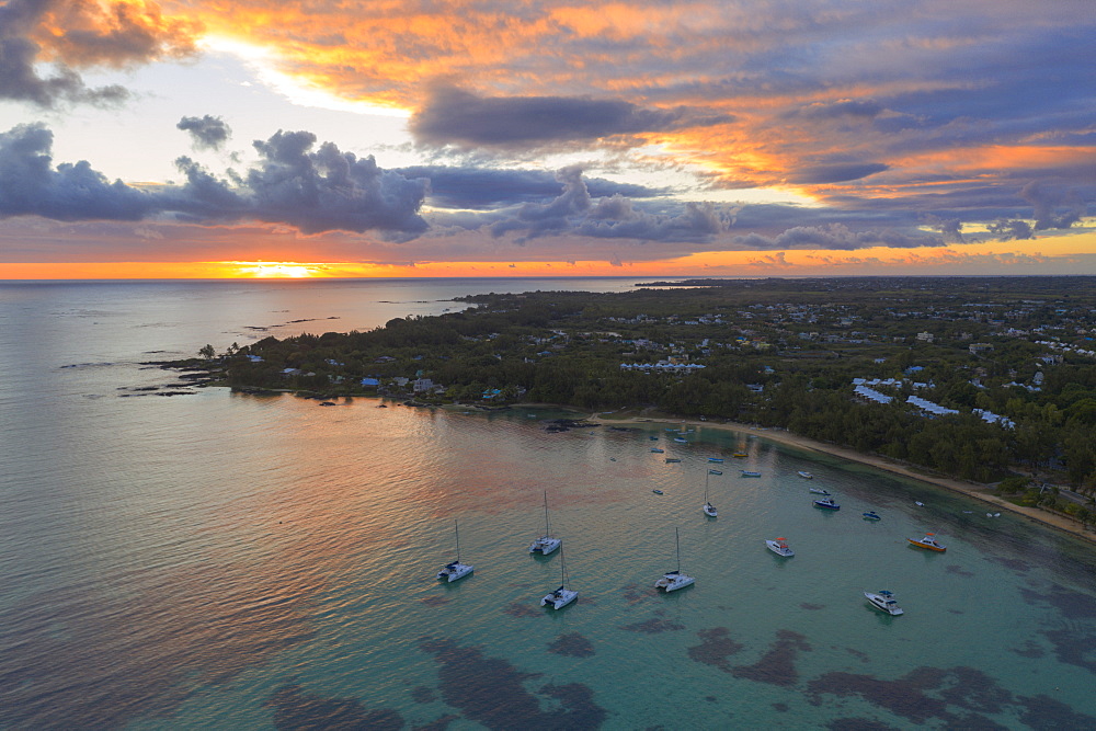 Orange sky at sunrise over the tropical beach and lagoon, aerial view, Grand Baie (Pereybere), Mauritius, Indian Ocean, Africa