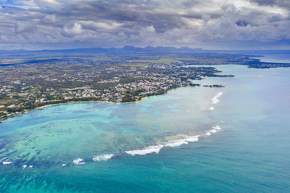 Dramatic sky over coral reef and inland, aerial view by drone Grand Baie (Pereybere), north-west coast, Mauritius, Indian Ocean, Africa