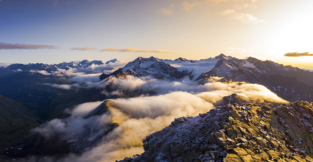 Aerial panoramic of low clouds covering Corno Tre Signori, Pizzo Tresero and Punta San Matteo peaks, Valtellina, Lombardy, Italy, Europe