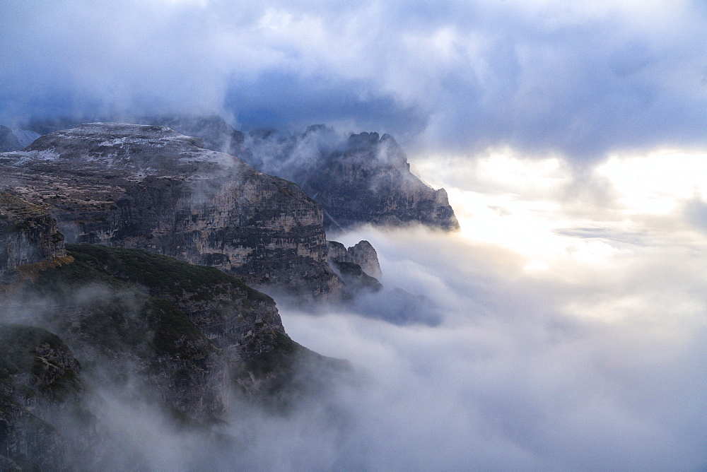 Sunlight over Croda dei Toni through the autumn fog covering Auronzo Valley, Sesto Dolomites, Trentino-Alto Adige/Veneto, Italy, Europe