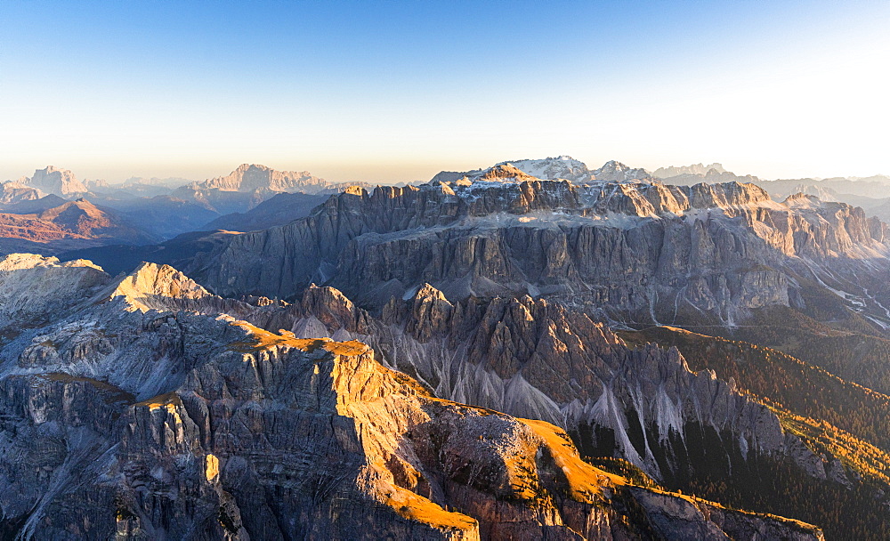 Aerial view of autumn sunset on rocky peaks of Sella Group, Val Gardena, Val di Fassa, Dolomites, South Tyrol, Italy, Europe