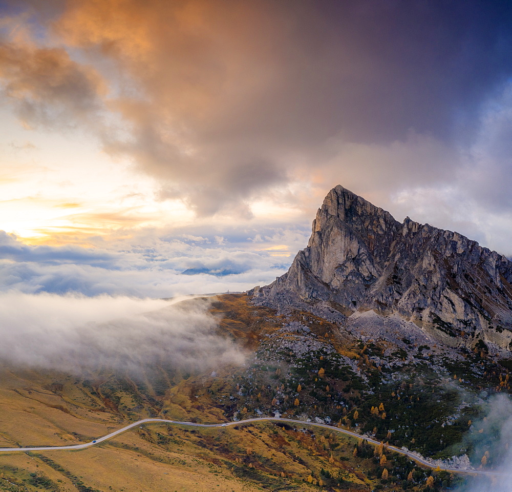 Aerial view by drone of foggy sky at sunset over Ra Gusela and Giau Pass in autumn, Dolomites, Belluno, Veneto, Italy, Europe