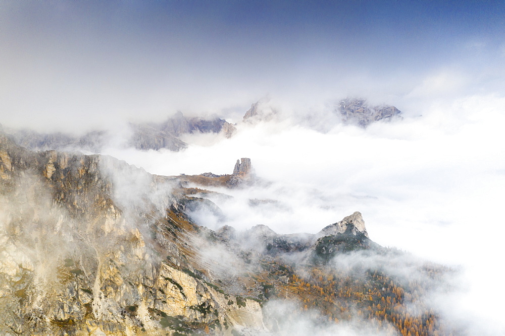 Aerial view of autumn mist over the trees and woods surrounding Cinque Torri and Tofane, Giau Pass, Dolomites, Belluno, Veneto, Italy, Europe