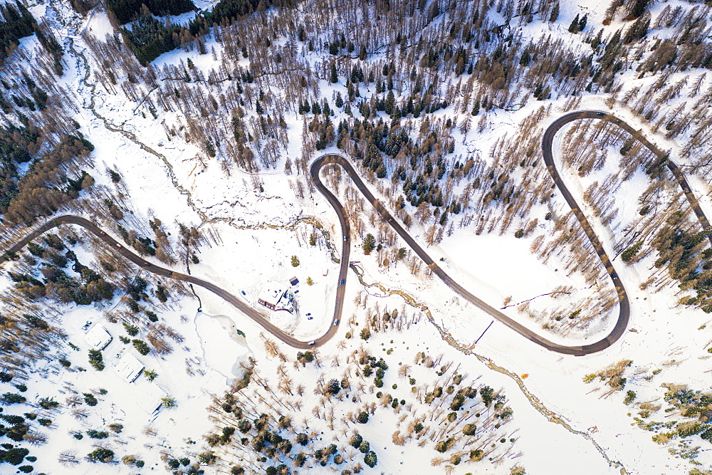 Aerial view of hairpin bends of mountain road through snowy woods, Passo Tre Croci, Dolomites, Belluno province, Veneto, Italy, Europe