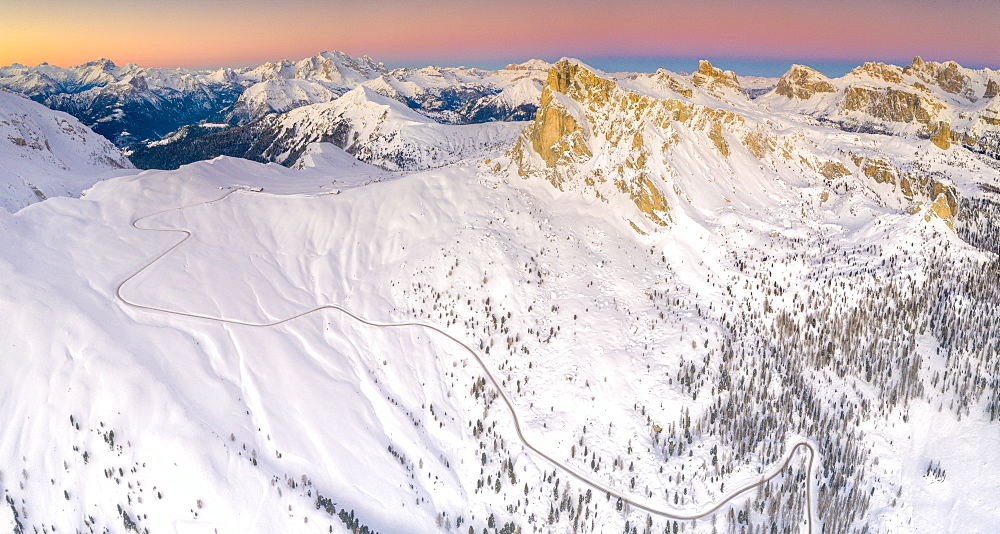 Panoramic view by drone of the snowy Giau Pass, Marmolada, Ra Gusela, Nuvolau, Averau and Lagazuoi at dawn, Dolomites, Veneto, Italy, Europe