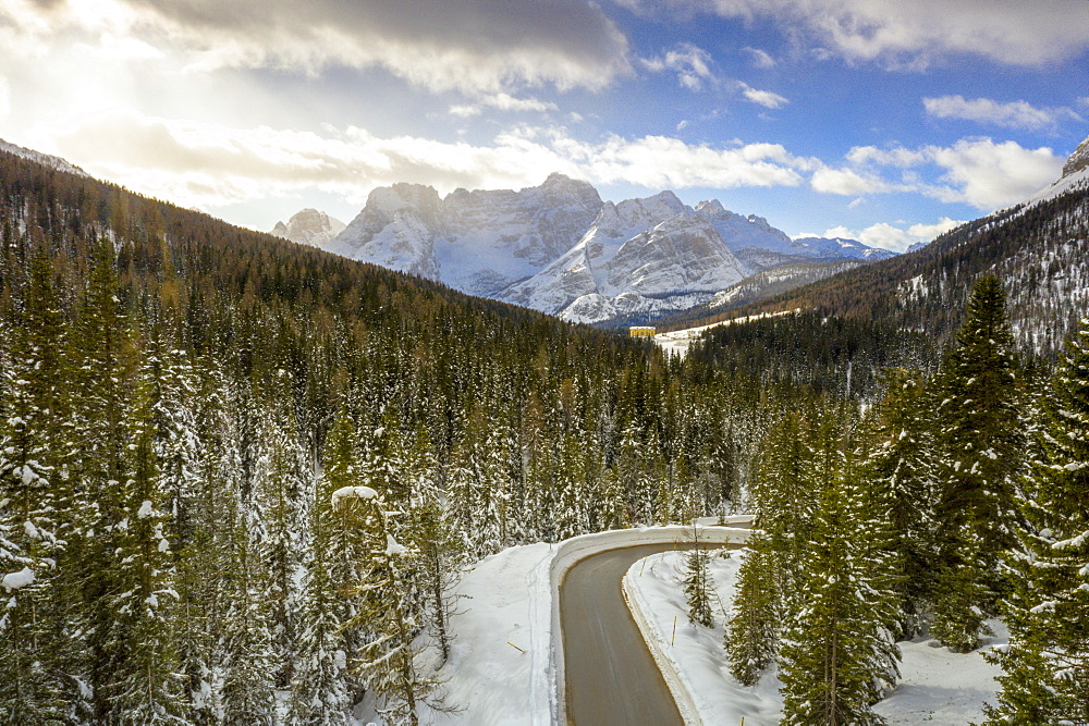 View by drone of empty road along the snowy forest connecting Antorno and Misurina, Dolomites, Belluno province, Veneto, Italy, Europe