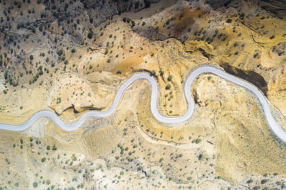 Aerial view by drone of hairpin bends of empty road along Danakil desert from above, Afar Region, Ethiopia, Africa