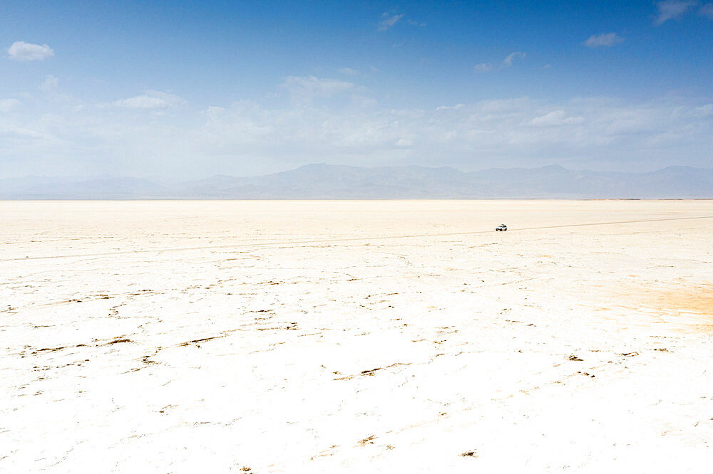 Off road vehicle crossing desert towards salt mines of Dallol, aerial view, Danakil Depression, Afar Region, Ethiopia, Africa