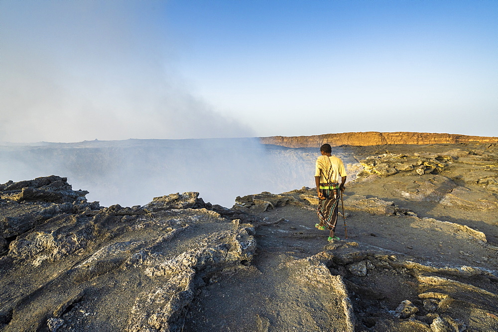 Afar man looking down to Erta Ale volcano caldera, Danakil Depression, Afar Region, Ethiopia, Africa