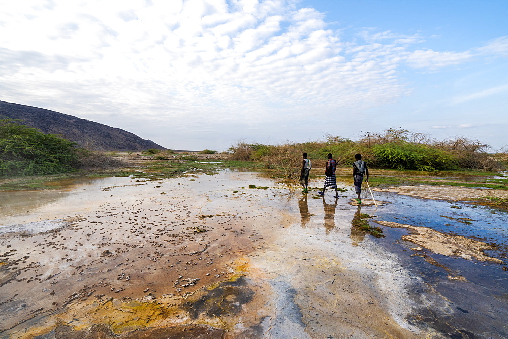 Afar men walking towards Ala Lobet (Alol Bet) geyser, Semera, Afar Region, Ethiopia, Africa