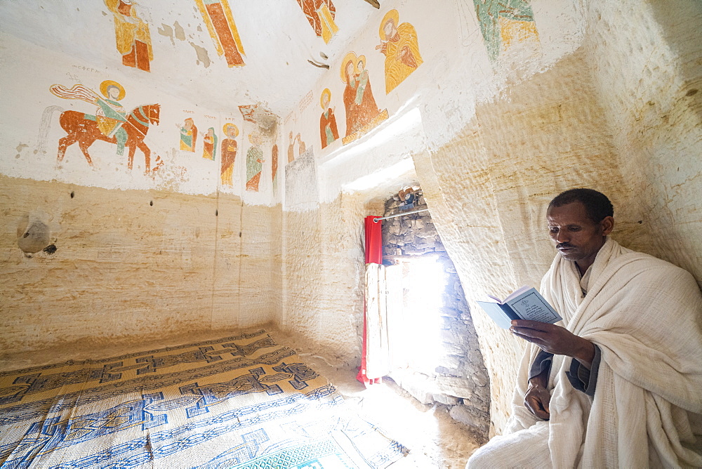 Priest holding the prayer book in the Orthodox Christian Daniel Korkor church, Gheralta Mountains, Tigray Region, Ethiopia, Africa