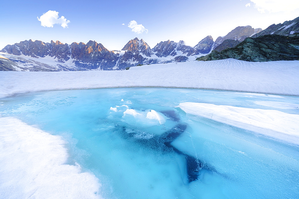 Melting ice on surface of Forbici Lake during spring thaw, Valmalenco, Valtellina, Sondrio province, Lombardy, Italy, Europe