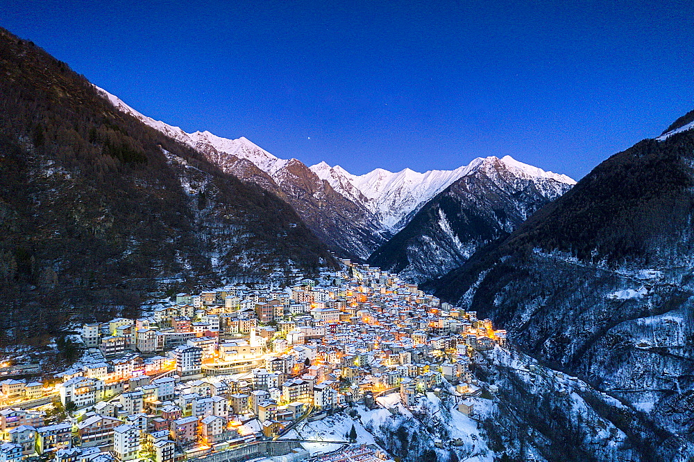 View by drone of winter dusk over the illuminated village of Premana, Valsassina, Lecco province, Lombardy, Italy , Europe