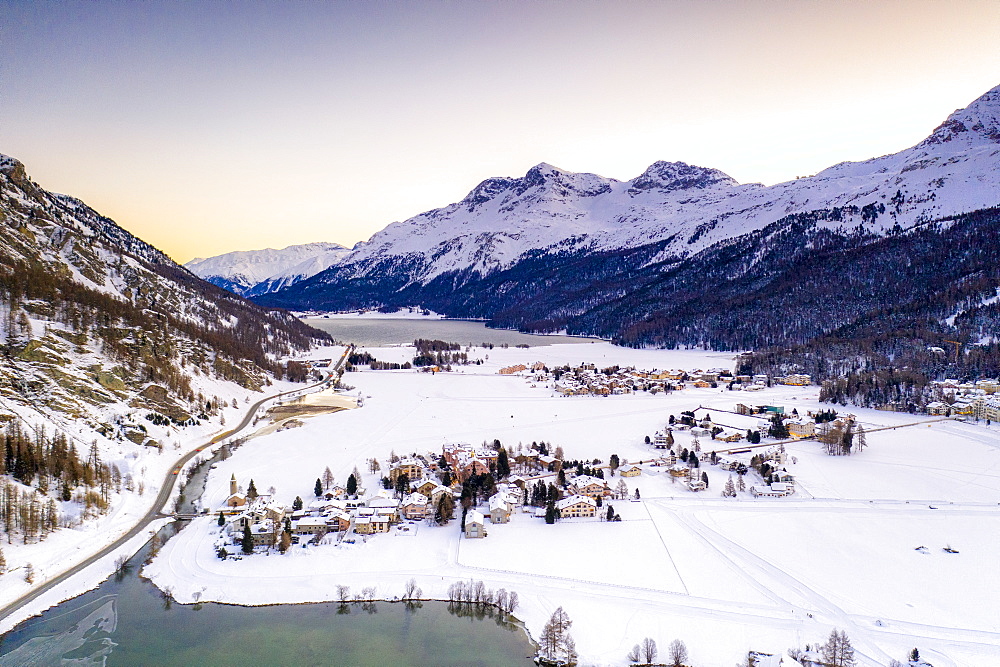 Snowy village of Segl (Sils im Engadin) on shores of Lake Sils at dawn, Engadine, canton of Graubunden, Switzerland, Europe