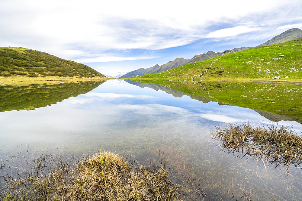 Clouds over mountains reflected in Porcile Lakes, Tartano Valley, Valtellina, Sondrio province, Lombardy, Italy, Europe