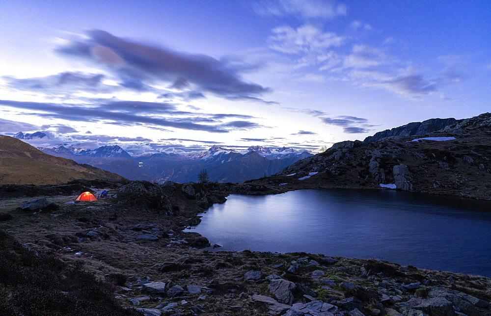 Tent of hikers on shores of the alpine lake Zana during sunrise, Valmalenco, Sondrio province, Valtellina, Lombardy, Italy, Europe