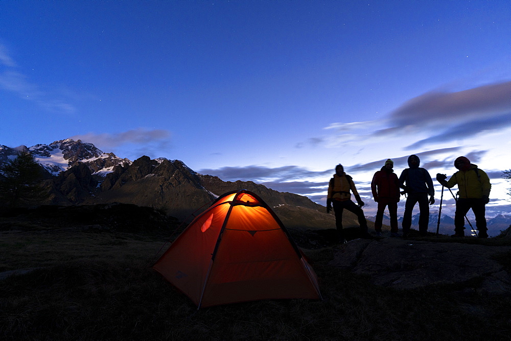 Hikers camping with tent photographing Monte Disgrazia at night, Valmalenco, Sondrio province, Valtellina, Lombardy, Italy, Europe