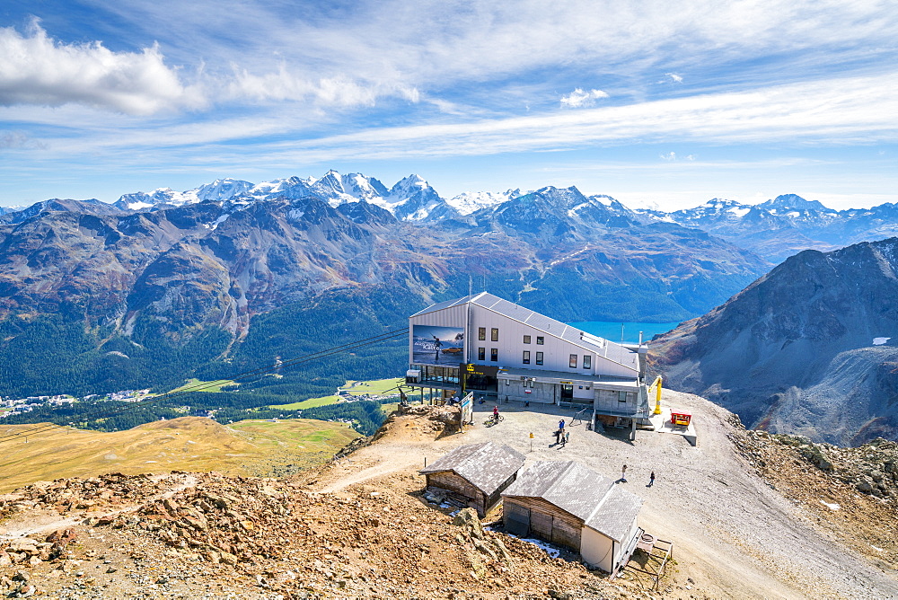 Aerial by drone of tourists at the cable car station on top of rocky peak of Piz Nair, Engadine, canton of Graubunden, Switzerland, Europe