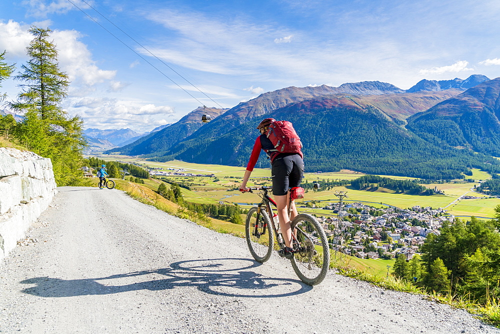 Mountain bikers on downhill path towards Celerina, Engadine, canton of Graubunden, Switzerland, Europe